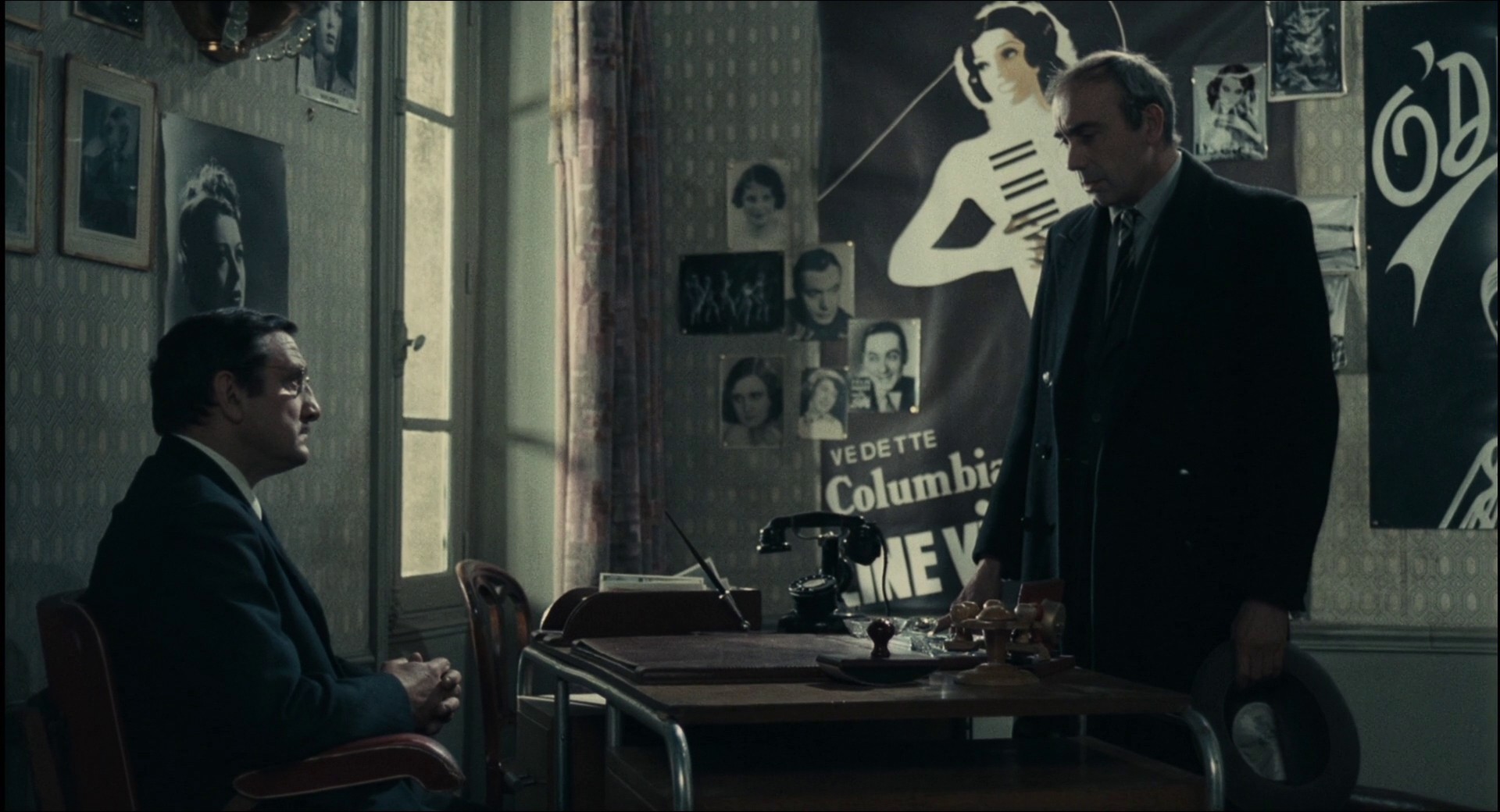 Screenshot of the film Army of Shadows (L'Armee des ombres), featuring with two sharp-suited men.