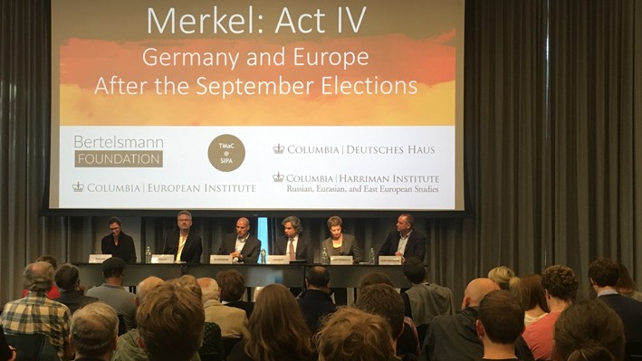 Panelists on stage discuss German elections results and implications, with an attentive audience at Columbia University.