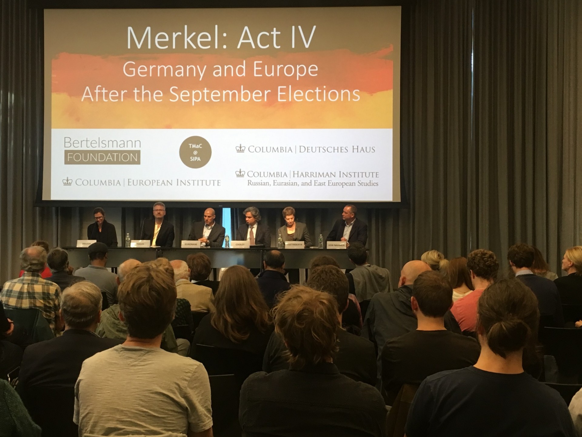 Panelists on stage discuss German elections results and implications, with an attentive audience at Columbia University.