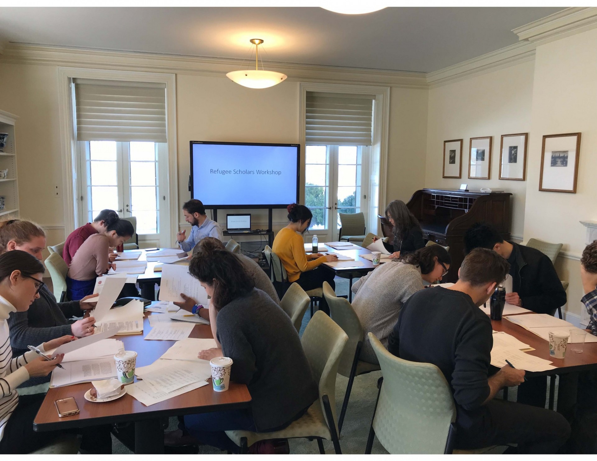 Students pore over archived documents as part of the Refugee Scholars Workshop hosted by the Rockefeller Archive Center