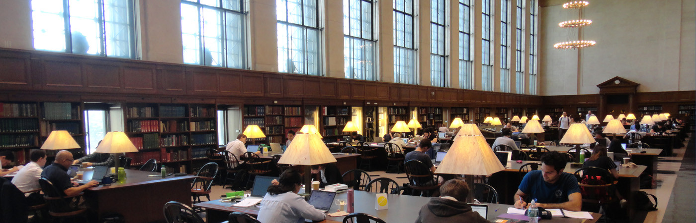 Students study and work at tables inside of Columbia University's Butler Library