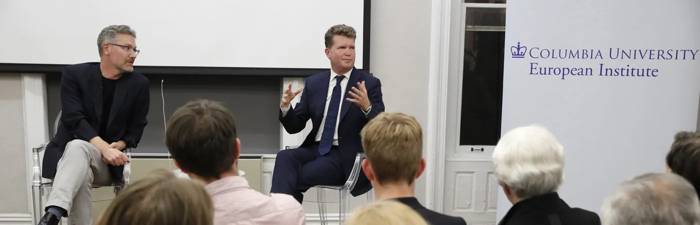 Professor Adam Tooze and Ambassador Matthew Barzun, seated next to the European Institute's banner, address a captivated room.