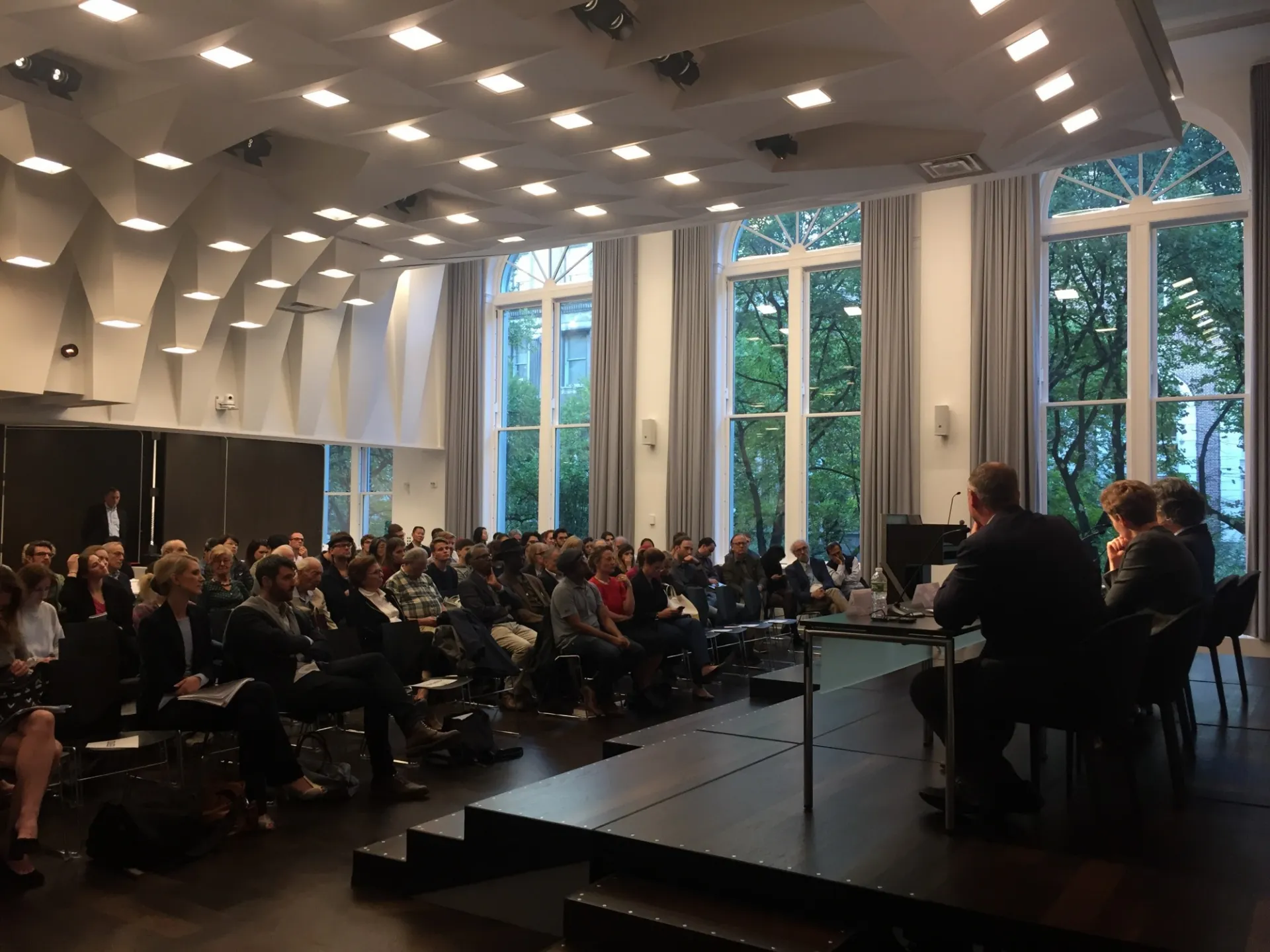 Panelists on stage discuss German elections results and implications, with an attentive audience at Columbia University.