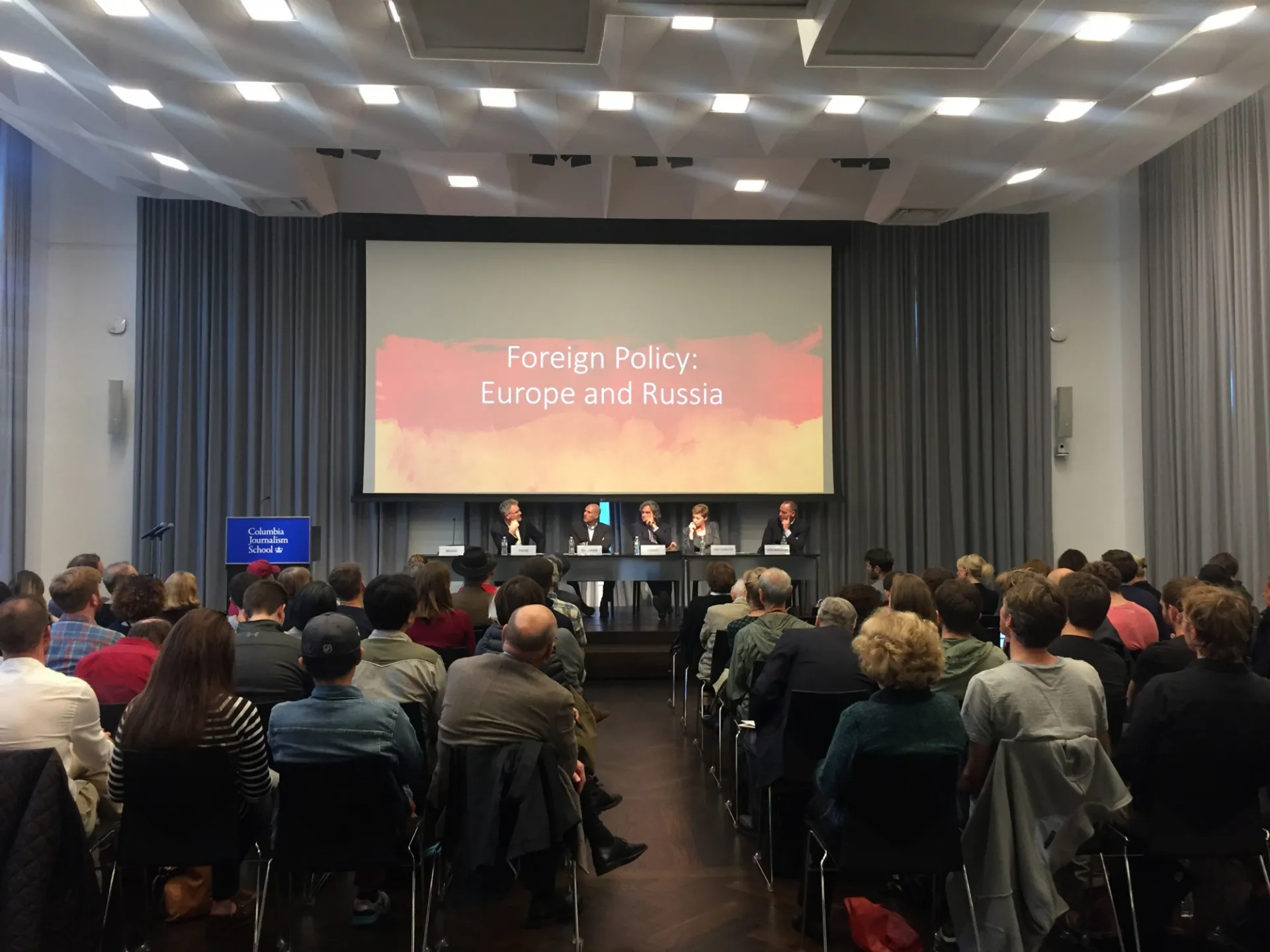 Panelists on stage discuss German elections results and implications, with an attentive audience at Columbia University.