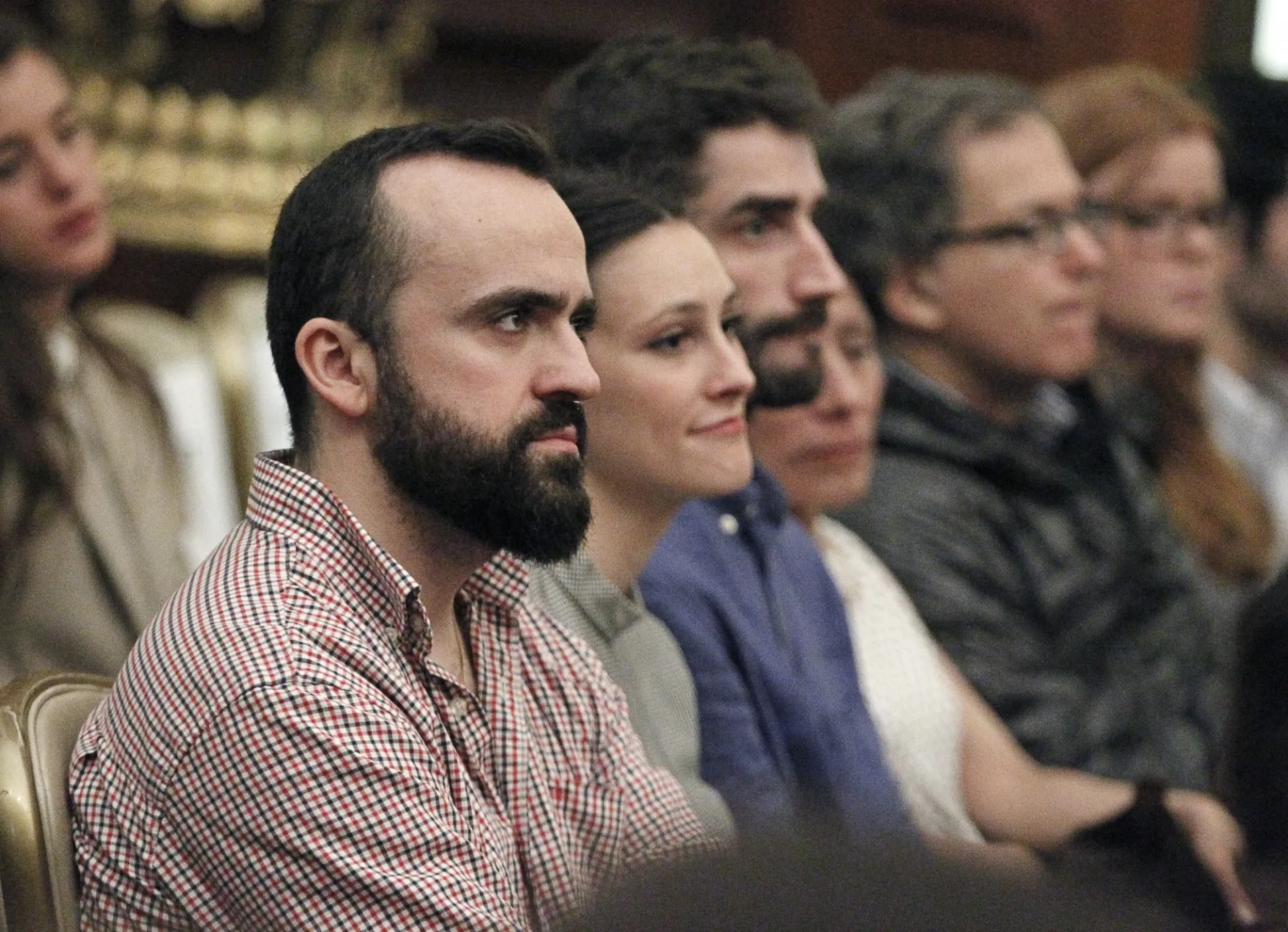 Columbia University students in the audience listen intently to the speaker